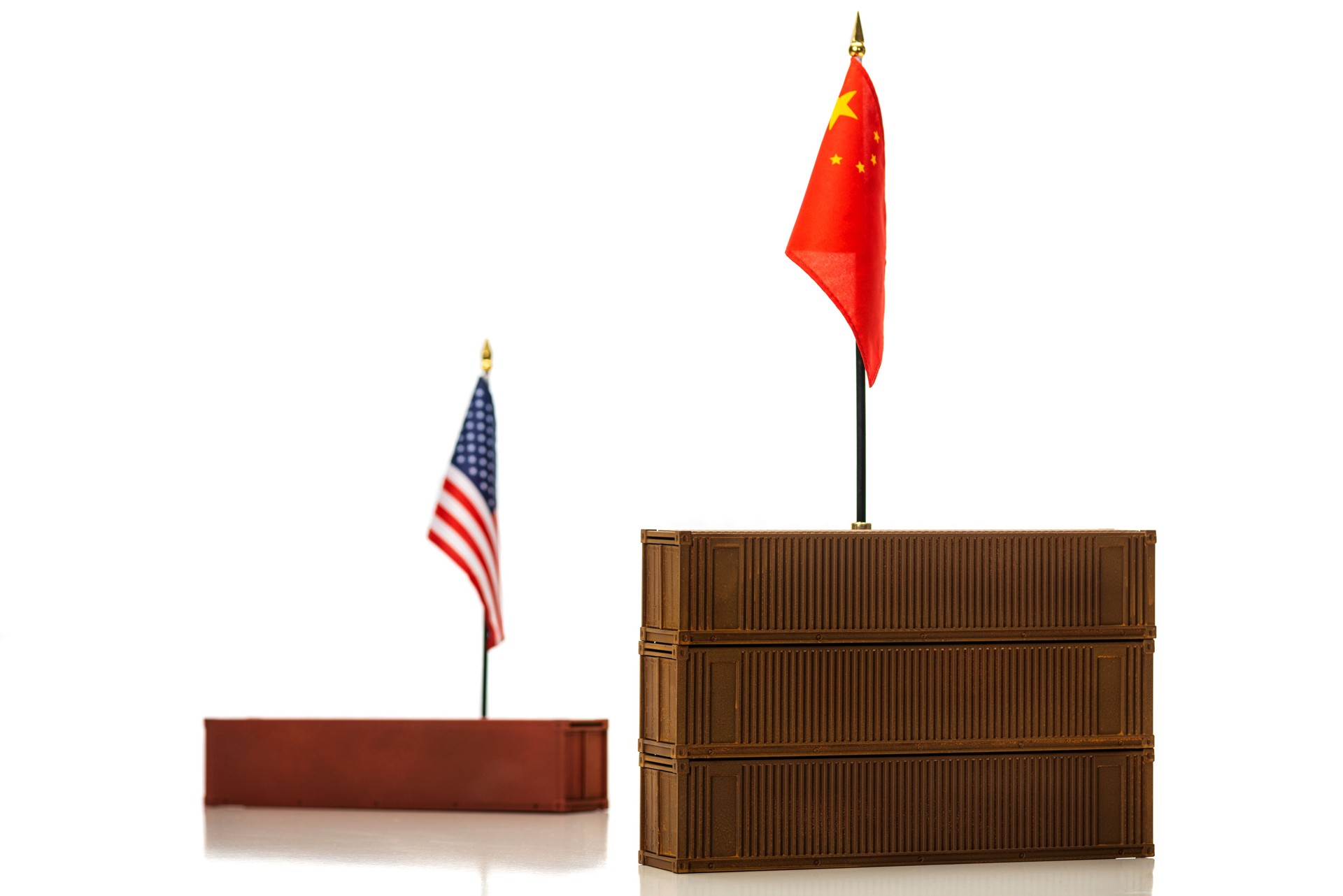 A Chinese flag with stacked shipping containers with an America flag way behind - Concept Trade deficit